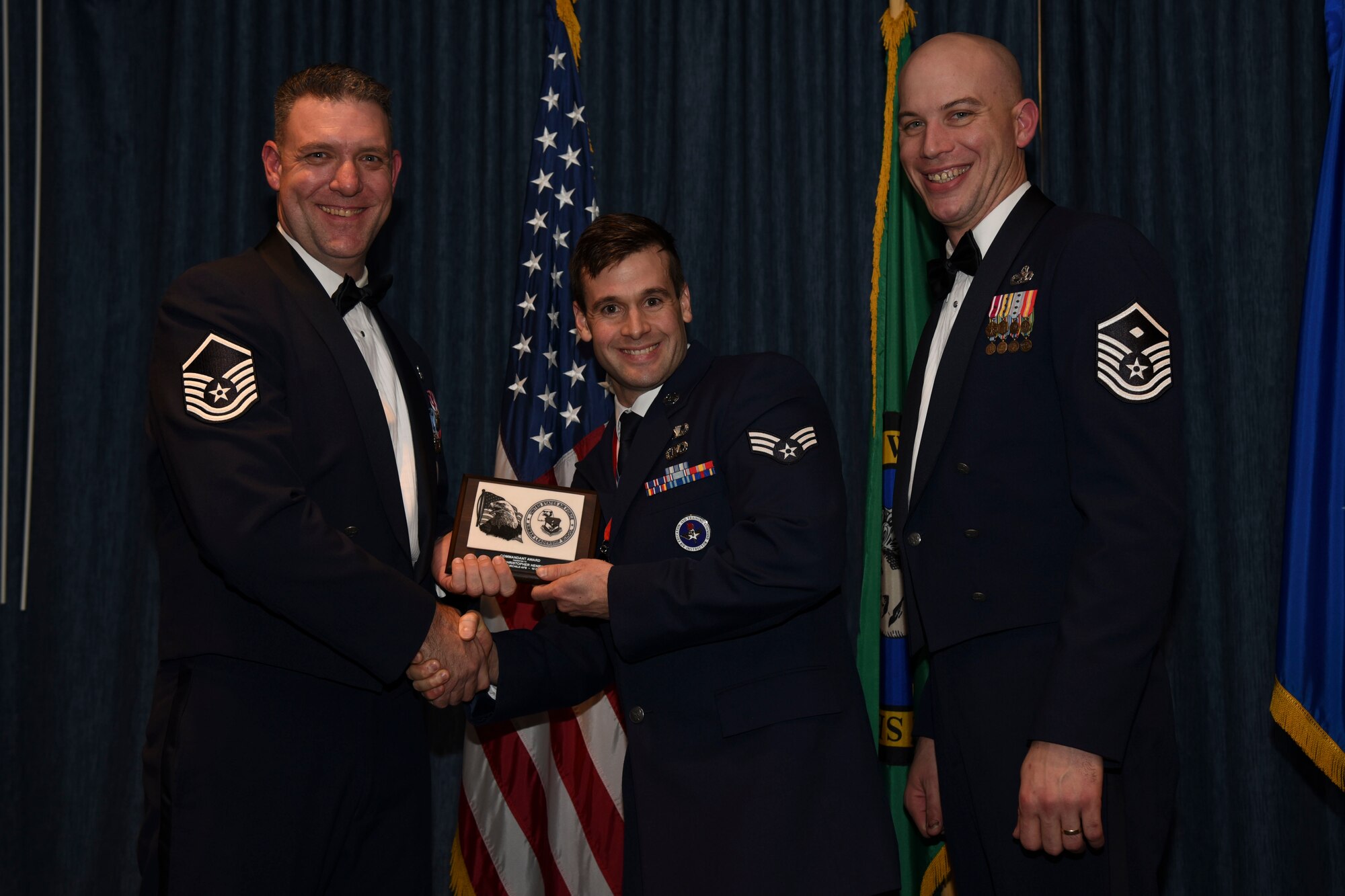 Senior Airman Christopher Henry from the 22nd Training Squadron receives the Commandant Award during the Airman Leadership School graduation Dec. 10, 2015, at Fairchild Air Force Base, Wash. The Commandant Award recipient is selected by the commandant based on their leadership skills. (U.S. Air Force photo/Airman 1st Class Mackenzie Richardson)
