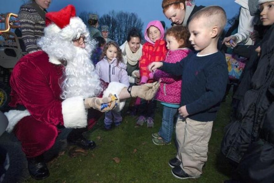 Santa Claus hands out candy to children Dec. 1 during the annual tree lighting ceremony on McChord Field. (Photo by Scott Hansen/Northwest Guardian)