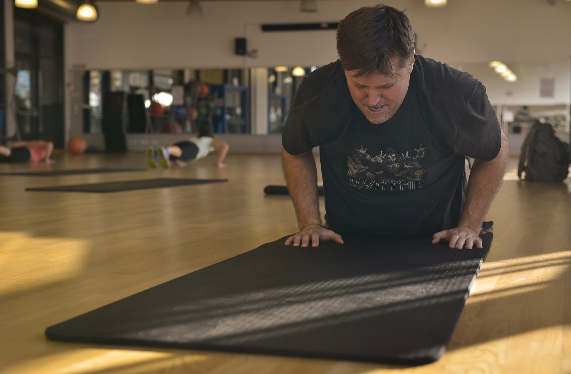 A Tabata class participant recuperates after planking sessions Dec. 7, 2015, at the Ramstein Southside Fitness Center on Ramstein Air Base, Germany. The fitness center provides multiple classes for people looking for an organized exercise schedule. (U.S. Air Force photo/Airman 1st Class Lane T. Plummer)