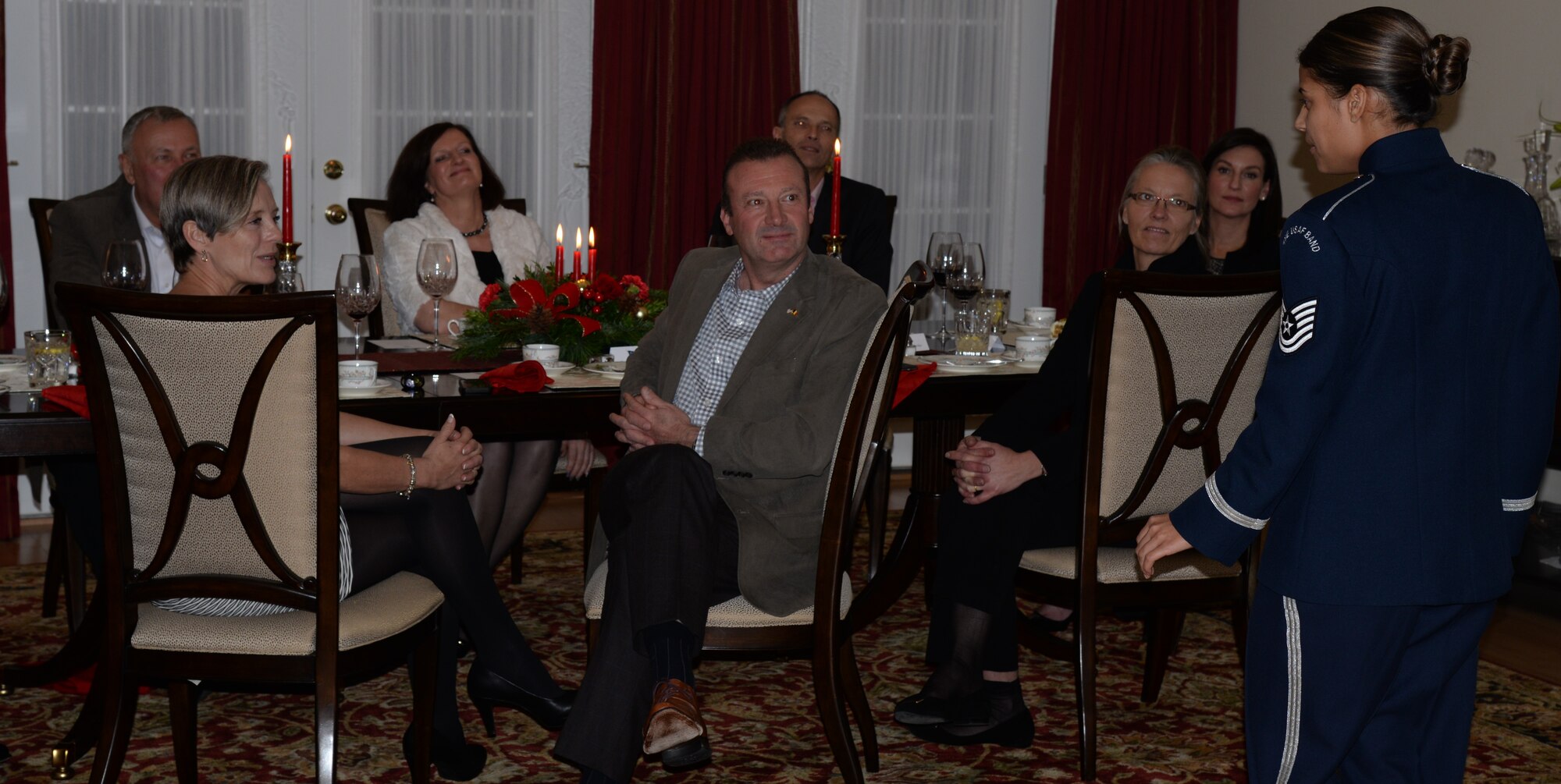 Air Force District of Washington Commander Maj. Gen. Darryl Burke, Ms. Kimberlee DeWitt and Air Attachés from Germany, Denmark, and Belgium listen to Technical Sgt. Nalani Quintello, a vocalist for the United States Air Force Band’s Max Impact, perform a Holiday medley Dec. 10, 2015. Burke hosted the Air Attachés at his residence to help build and sustain relationships between the U.S. and their respective countries. Air Force District of Washington provides manpower, personnel and services support for designated Air Force activities within the National Capital Region and for more than 26,000 Airmen performing duties worldwide in 108 countries. (U.S. Air Force Photo/1 Lt. Esther Willett)
