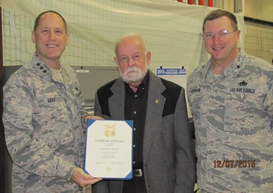 Air Force Sustainment Center Commander Lt. Gen. Lee Levy II, left, and Oklahoma City Air Logistics Complex Commander Brig. Gen. Mark Johnson celebrate Coleman Miller’s 50 years of federal service during a Dec. 7 ceremony. Mr. Miller, 544th Propulsion Maintenance Squadron unit chief, began his federal career on Nov. 8, 1955, as an apprentice at the Naval Ordnance Station Louisville in Louisville, Ky. He has served in many positions throughout his career, but said his favorite job was qualification of Navy standard missile hardware for manufacturing by Naval Ordnance. He has collaborated with the Army, Marine Corps and Naval defense contracts to develop, prototype and qualify military hardware for production. He served as first line supervisor in Heat Treatment, Plating, Paint and Thermal Spray; as unit chief in Special Processes, General Machining, General Welding and F100 engines; as well as on numerous transformation projects including TF33 and F100 engines. Mr. Miller has been at Tinker for 20 years. He said getting his 50-year pin became a personal goal after he received his 30-year pin. (Air Force photo by Joye Vanzandt/Released)

