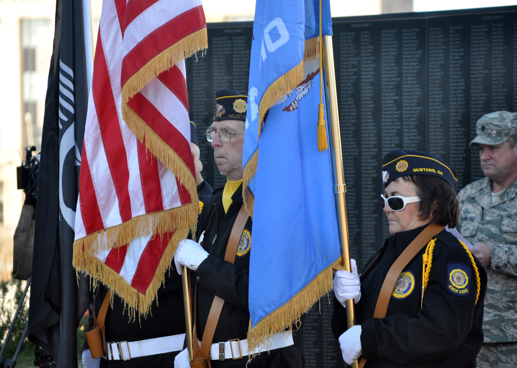 Army veteran Jerry Ashley, left, and Air Force veteran Karen Douthit carry the colors during a ceremony honoring veterans and the 2,403 U.S. personnel who died in the Dec. 7, 1941, Japanese attack on United States Naval Base, Pearl Harbor, Hawaii Territory. American Legion Post 353 of Mustang and organizer Laquetha Guthrie Young, regent of the Oklahoma City chapter of the Daughters of the American Revolution, hosted a 10:30 a.m. Wreaths Across America statehouse ceremony Monday at the Oklahoma Veterans Memorial at State Capitol Park. (Air Force photo by John Parker/Released)
