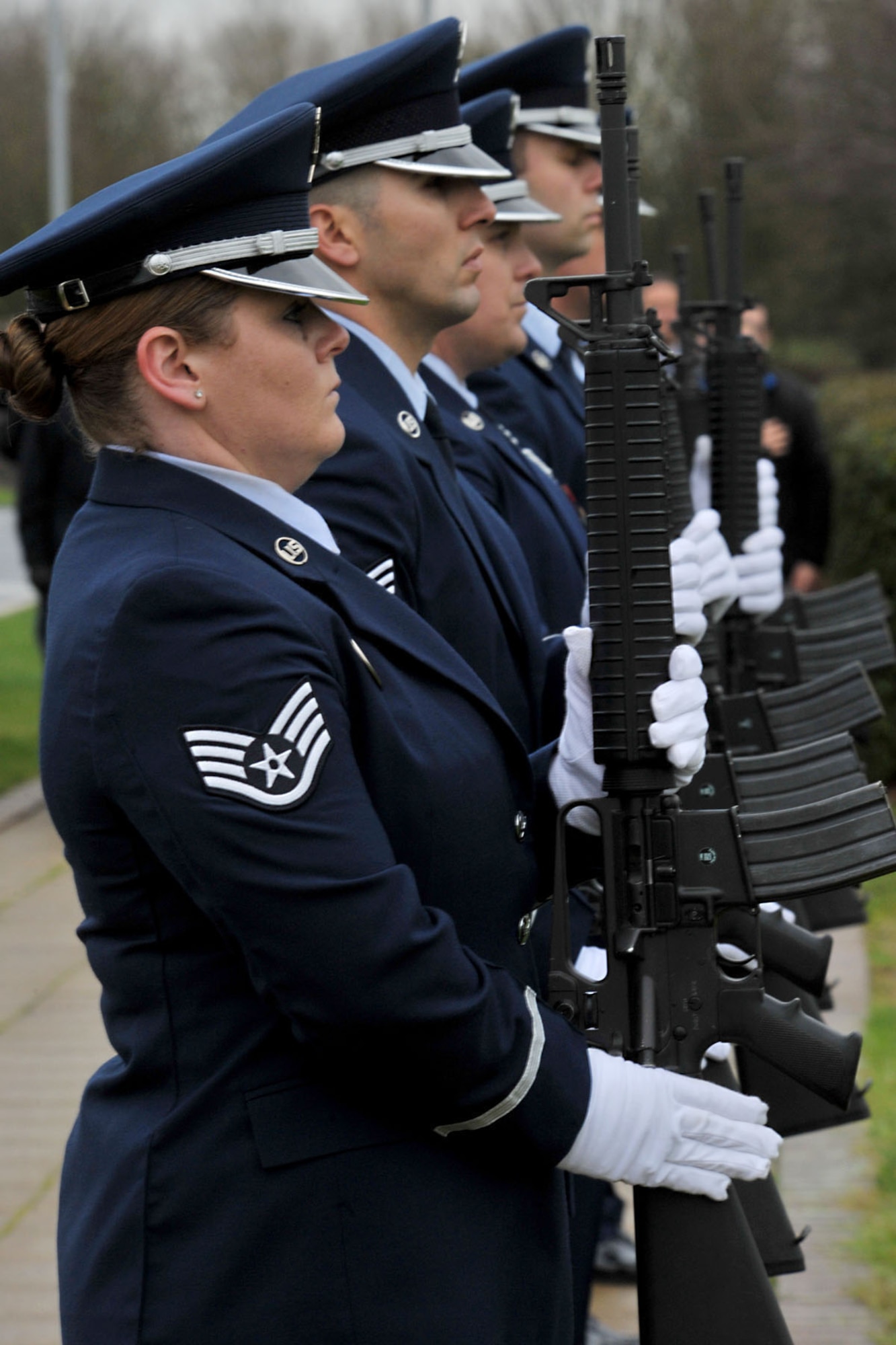The 423rd Air Base Group Honor Guard presents arms while Taps is played, during the 74th Pearl Harbor Commemoration Ceremony at RAF Molesworth, United kingdom, Dec. 7, 2015. The ceremony included a three-volley salute by the honor guard and a formation salute as 48th Fighter Wing F-15 Eagle pilots performed a flyby. (U.S. Air Force photo by Staff Sgt. Ashley Tyler/Released)