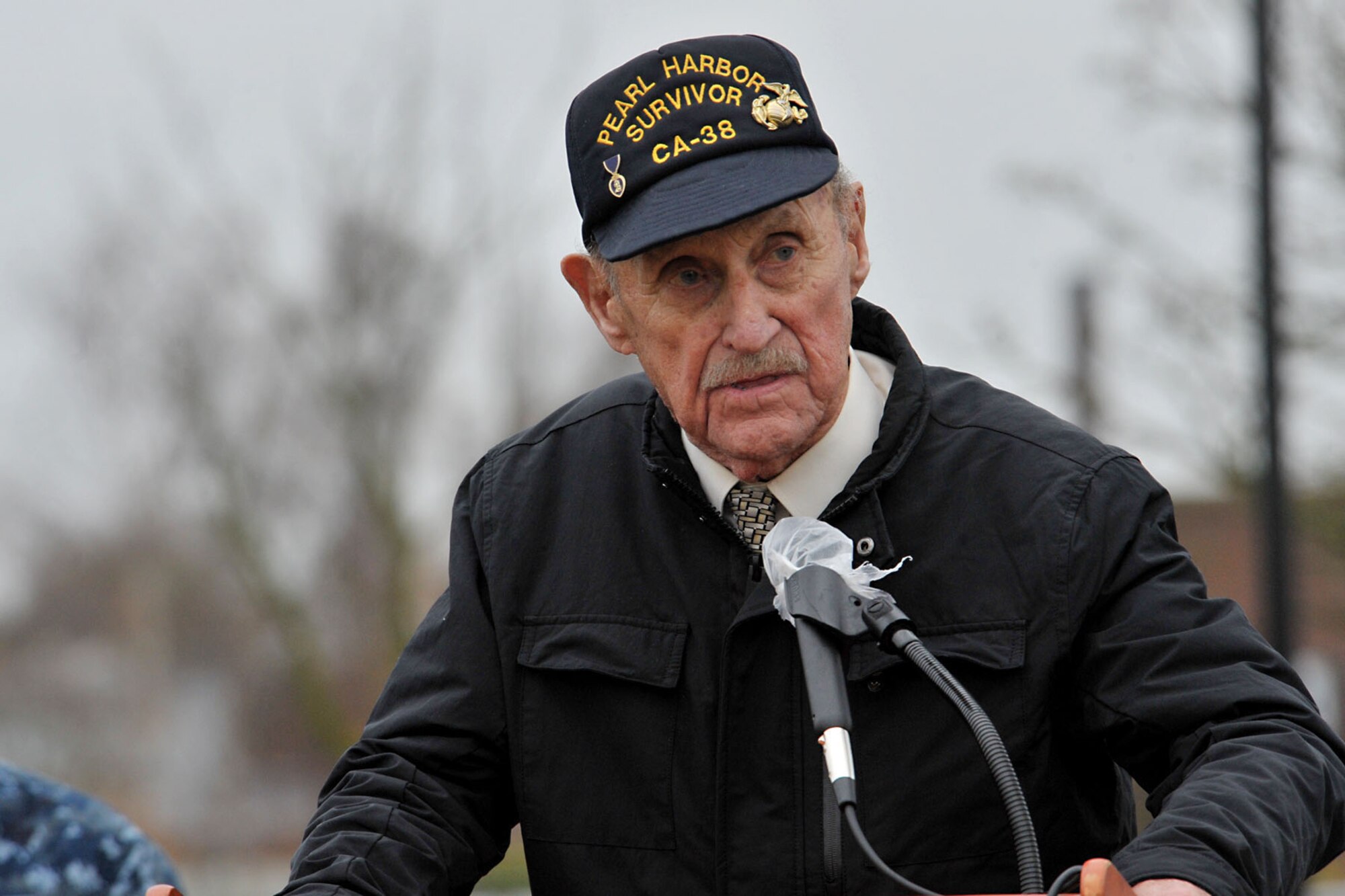 Former U.S. Marine Corps Sgt. John Egan says a few words during the 74th Pearl Harbor Commemoration Ceremony at RAF Molesworth, United Kingdom, Dec. 7, 2015. Egan is a Pearl Harbor survivor and was aboard the USS San Francisco (CA-38) during the attack. He was awarded the Purple Heart in November 1942 for wounds sustained at the Naval Battle of Guadalcanal and remains the youngest Marine to obtain the rank of Sgt. (U.S. Air Force photo by Staff Sgt. Ashley Tyler/Released)