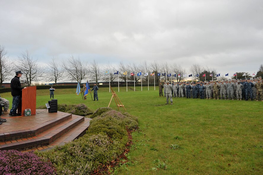 U.S. Navy Capt. Daryl Hancock, far left, Maritime Command, RAF Northwood senior national U.S. representative, addresses the crowd during the 74th Pearl Harbor Commemoration Ceremony at RAF Molesworth, United Kingdom, Dec. 7, 2015. In addition to the guest speaker, the ceremony included a three-volley salute by the 423rd Honor Guard, and a formation salute as the 48th Fighter Wing F-15 Eagle pilots performed a flyby. (U.S. Air Force photo by Staff Sgt. Ashley Tyler/Released)