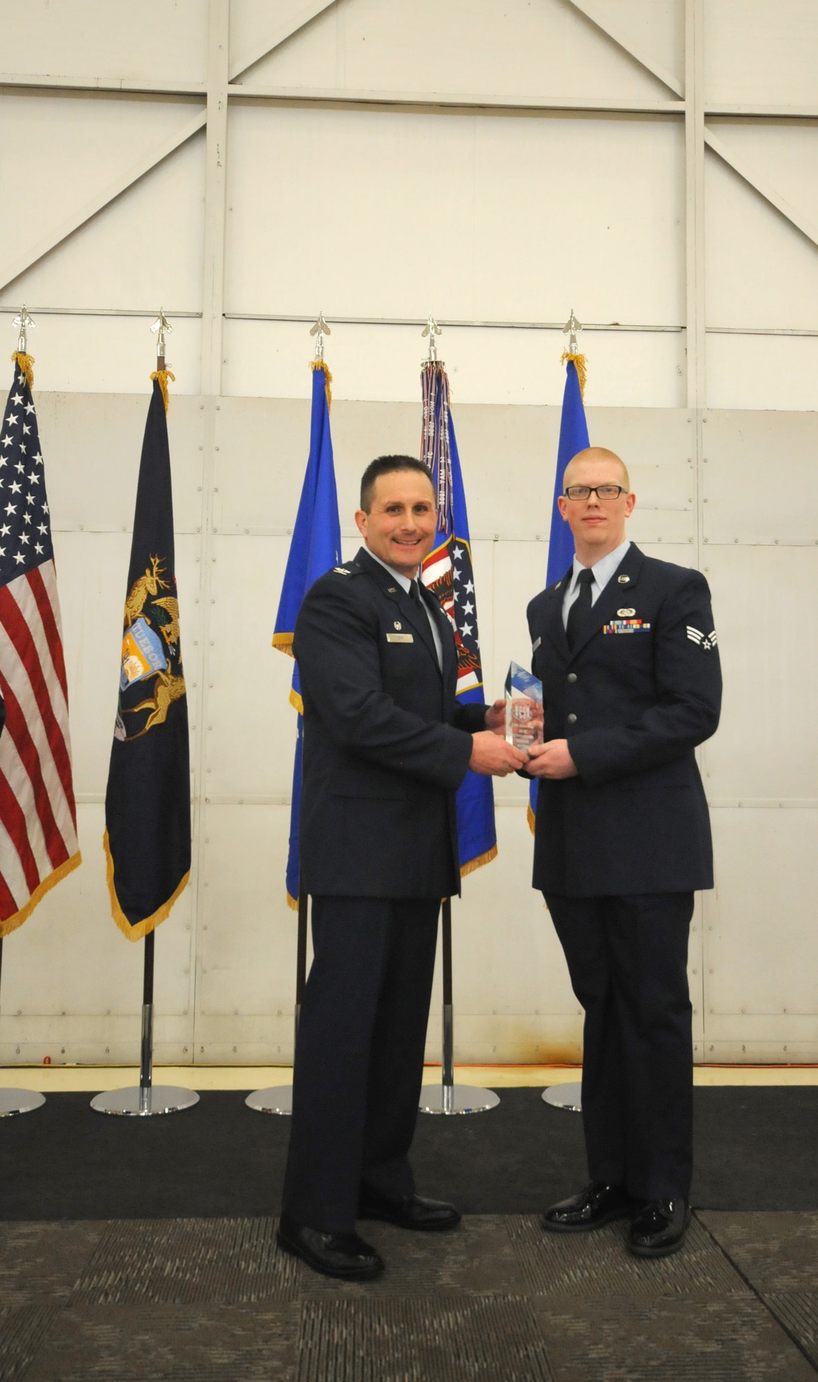 Col. Bryan Teff announces and congratulates the 2015 Airman of the Year recipients, Saturday, December 5, 2015, Battle Creek Air National Guard Base, Mich. Members awarded include, Airman of the Year, Senior Airman Erik Elliot, 110th Operations Support Squadron, Non-Commissioned Officer of Year, Tech. Sgt. Richard Parker II, 217th Air Component Operations Squadron, Senior Non-Commissioned Officer of the Year, Master Sgt. Carl Westphal II, 217th Air Operations Squadron, Company Grade Officer of the Year, 1st Lt. Justin Andrews, 217th Air Component Operations Squadron, 1st Sgt. of the Year, Master Sgt. Darrell Kingsbury, 217th Air Operations Group, Honor Guard Member of the Year, Staff Sgt. Amanda Bean, Battle Creek Air National Guard Enlisted Memorial Scholarship recipient, Jacob Zahm, annual 110th Attack Wing Outstanding Unit Safety Representative, Master Sgt. Felica Harris, and Outstanding Individual Safety Contribution, Master Sgt. Luke Wimby, and 110th Attack Wing Guardsman of the year, Staff Sgt. Amanda Bean. (Air National Guard Photo by Master Sgt. Sonia Pawloski/released)