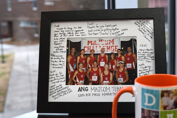 MCGHEE TYSON AIR NATIONAL GUARD BASE, Tenn. - A photo, autographed by Airmen on the Air National Guard's 2015 U.S. Air Force Marathon team, overlooks the I.G. Brown Training and Education Center campus here Dec. 11, 2015, atop Chief Master Sgt. Edward Walden's desk. Walden, TEC's commandant, managed the runners. They earned second place among other major commands that competed on Wright-Patterson Air Force Base in Ohio. (U.S. Air National Guard photo by Master Sgt. Mike R. Smith/Released)