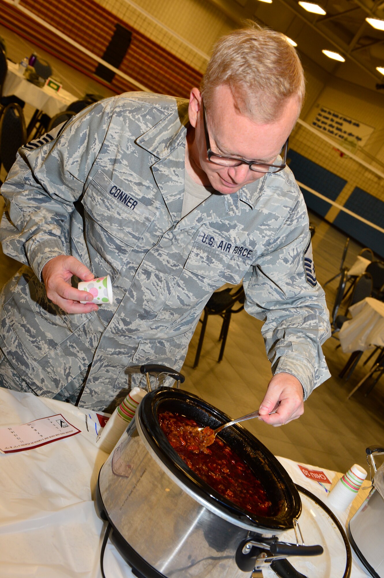 MCGHEE TYSON AIR NATIONAL GUARD BASE, Tenn. - Master Sgt. Bill Conner takes a scoop of chili at the  I.G. Brown Training and Education Center here, Dec. 2, 2015. The TEC held a chili cook-off as part of a series of fundraisers for the unit Holiday Party.(U.S. Air National Guard photo by Master Sgt. Jerry D. Harlan/Released)