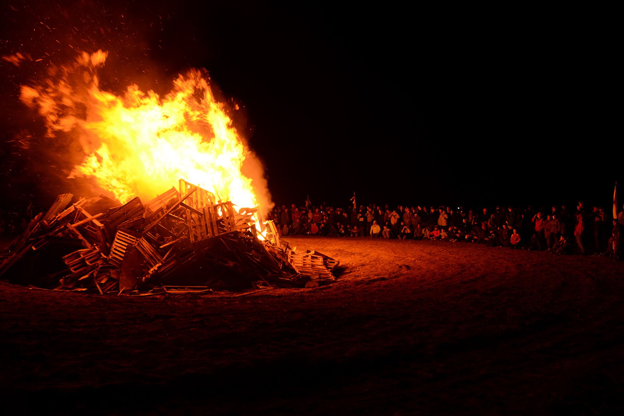Boy Scout troops view the bonfire at McEntire Joint National Guard Base, S.C., during the Swamp Fox Camporee Dec. 6, 2015. The event was hosted by the South Carolina National Guard to allow Cub Scouts and Boy Scouts the opportunity to interact with Guardsmen and compete to earn various merit badges. (U.S. Air National Guard photo by Airman Megan Floyd/RELEASED)