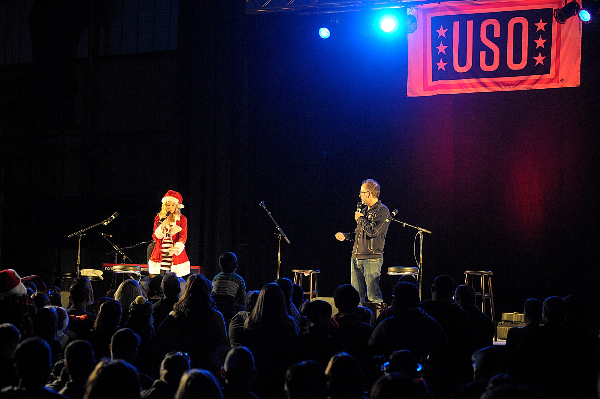 Actors Elizabeth Banks and David Wain talk with the crowd during the 2015 USO Holiday Troop Tour Dec. 9, 2015, at Ramstein Air Base, Germany. Ramstein was the last stop of the 15th annual tour. (U.S. Air Force photo/Staff Sgt. Timothy Moore)
