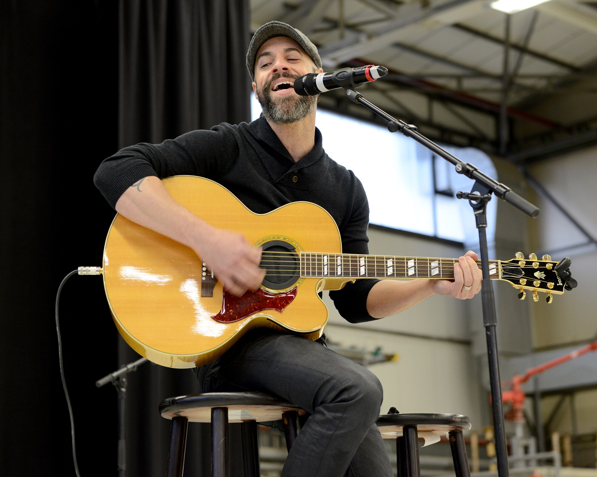 Musician Chris Daughtry sings a pre-show song Dec. 9, 2015, at Ramstein Air Base, Germany. Daughtry and other celebrities joined U.S. Marine Corps Gen. Joseph F. Dunford, chairman of the Joint Chiefs of Staff, for the 2015 USO Holiday Troop Tour to thank service members and their families for their service and sacrifices. (U.S. Air Force photo/Staff Sgt. Timothy Moore)