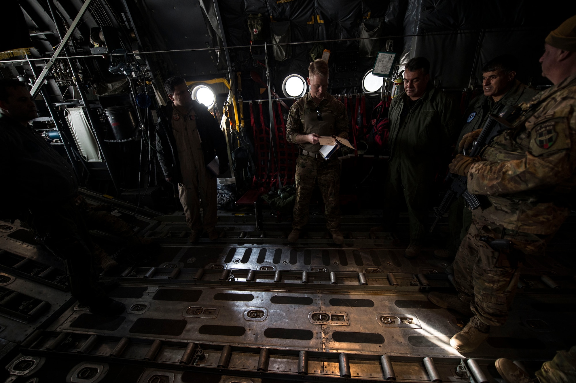 U.S Air Force aircrew assigned to the Train, Advise, Assist Command-Air (TAAC-Air) and their Afghan counterparts conduct a preflight brief on an Afghan Air Force C-130H Hercules at Hamid Karzai International Airport, Kabul, Afghanistan, Dec. 6, 2015. TAAC-Air advisors have grown the Afghan Air Force since 2006.  During this time, the Afghan Air Force has made daily strides toward becoming a professional, capable and sustainable Air Force. (U.S. Air Force photo by Staff Sgt. Corey Hook/Released)