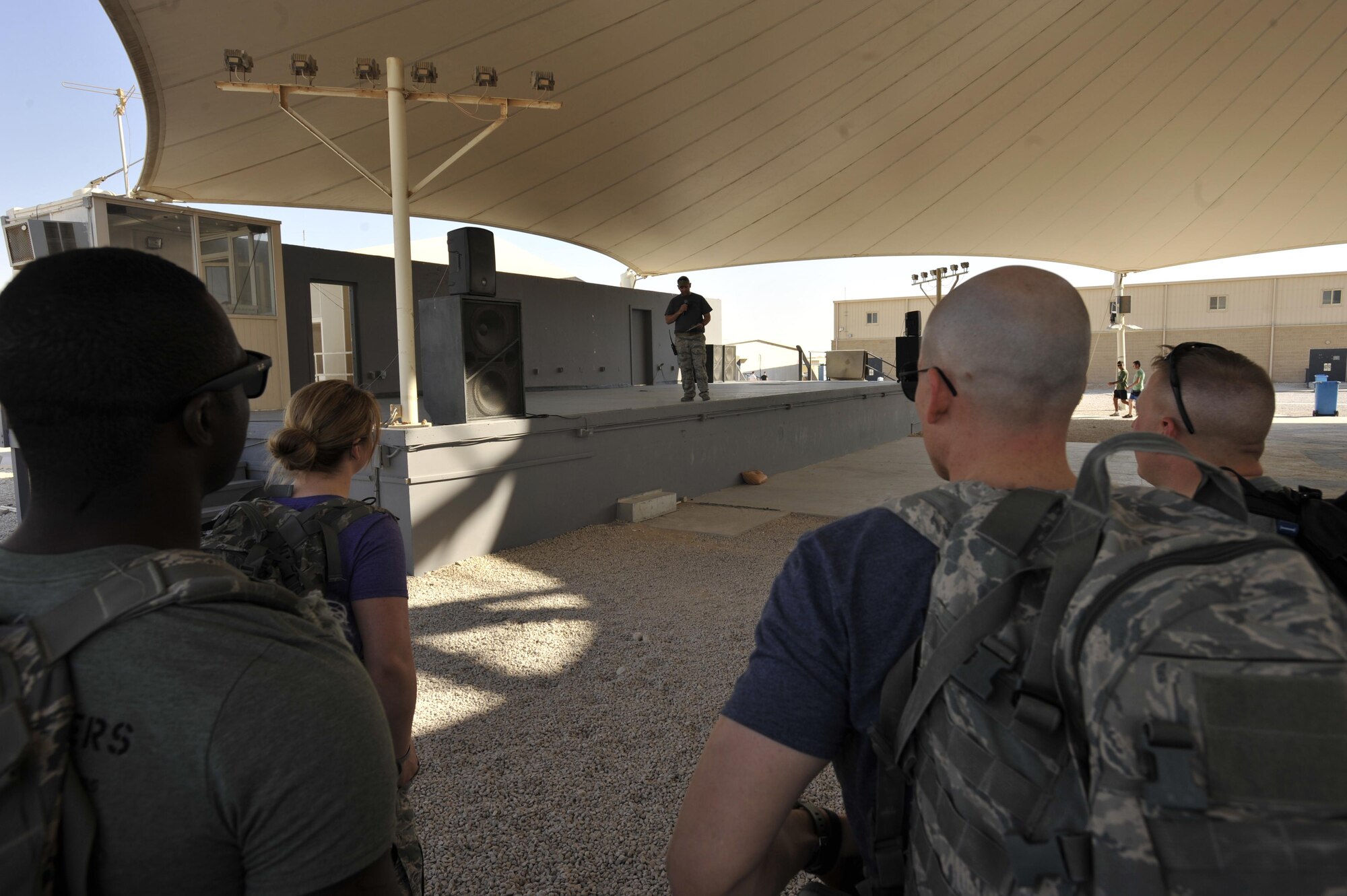Master Sgt. Austin Schneider, 379th Expeditionary Security Forces Squadron training superintendent, reads the names of the twelve Defenders being honored by the Fallen Defenders Ruck to Remember at Al Udeid Air Base, Qatar, Dec. 12, 2015. The 12 kilometer ruck march honors security forces Defenders who have made the ultimate sacrifice in support of operations in Iraq and Afghanistan. (U.S. Air Force photo by Master Sgt. Joshua Strang)