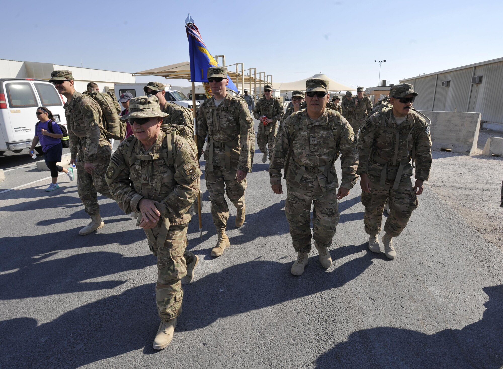 Members of Al Udeid Air Base, Qatar begin the Fallen Defenders Ruck to Remember here, Dec. 12, 2015. The 12 kilometer ruck march honors security forces Defenders who have made the ultimate sacrifice in support of operations in Iraq and Afghanistan. (U.S. Air Force photo by Master Sgt. Joshua Strang)