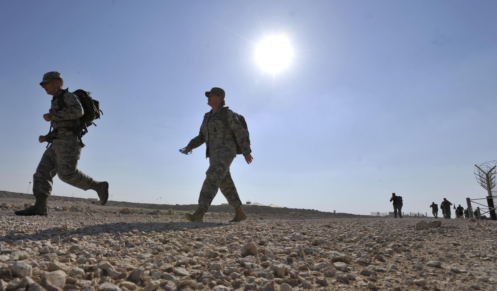 Members of Al Udeid Air Base, Qatar run and walk during the Fallen Defenders Ruck to Remember here, Dec. 12, 2015. The 12 kilometer ruck march honors security forces Defenders who have made the ultimate sacrifice in support of operations in Iraq and Afghanistan. (U.S. Air Force photo by Master Sgt. Joshua Strang)