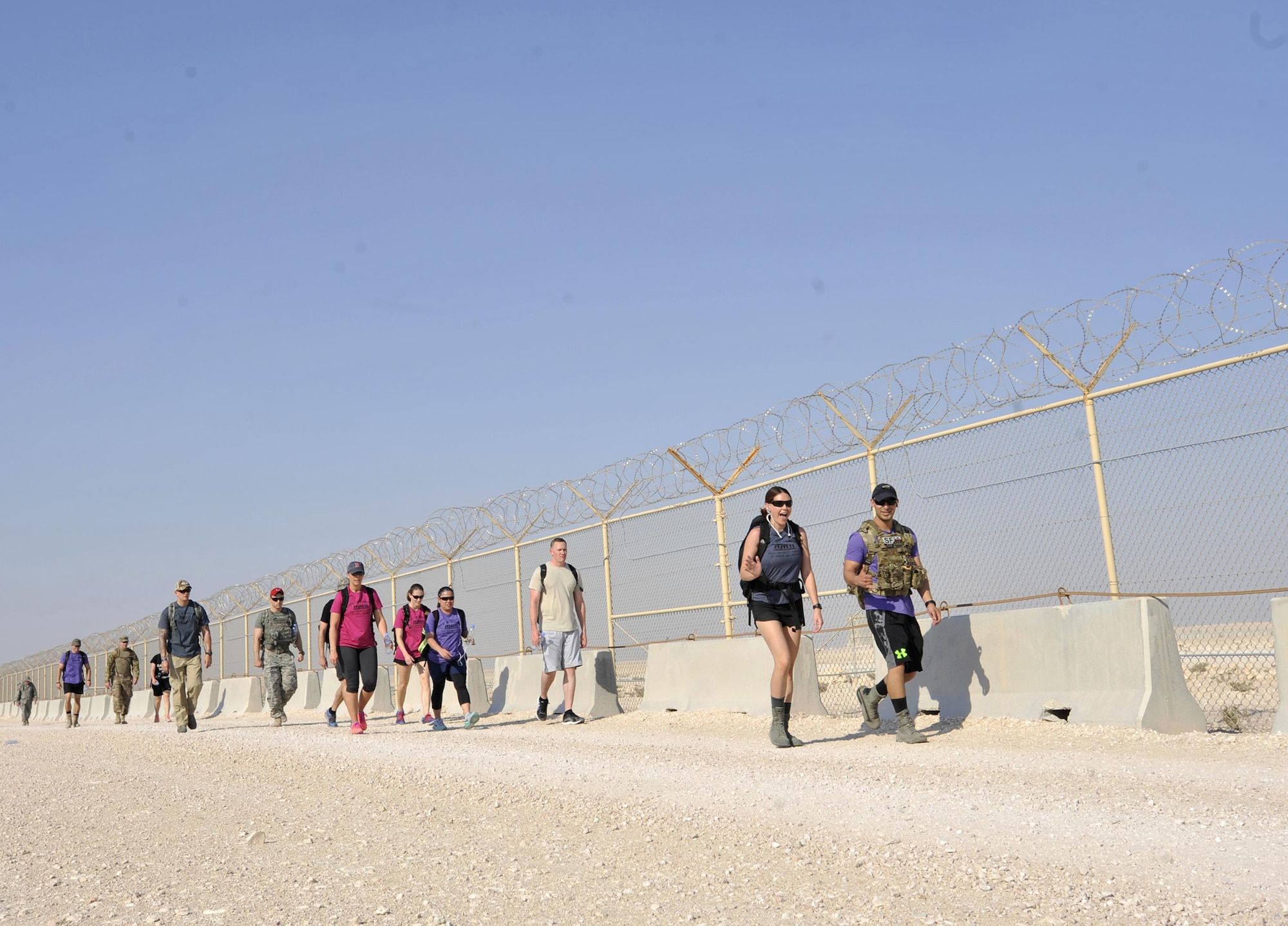 Members of Al Udeid Air Base, Qatar participate in the Fallen Defenders Ruck to Remember here, Dec. 12, 2015. The 12 kilometer ruck march honors security forces Defenders who have made the ultimate sacrifice in support of operations in Iraq and Afghanistan. (U.S. Air Force photo by Master Sgt. Joshua Strang)
