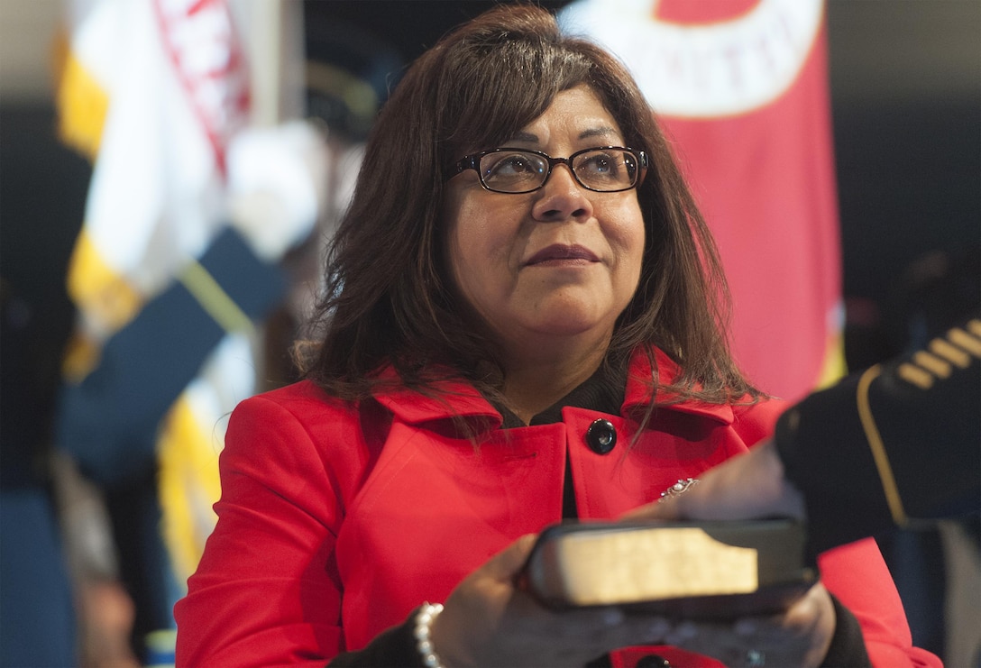 Sandra Troxell, wife of Army Command Sgt. Maj. John W. Troxell, listens as Marine Corps Gen. Joseph F. Dunford Jr., chairman of the Joint Chiefs of Staff, swears in Troxell as the third senior enlisted advisor to the chairman of the Joint Chiefs of Staff during a change of responsibility ceremony on Joint Base Myer-Henderson Hall, Va., Dec. 11, 2015. DoD photo by Navy Petty Officer 2nd Class Dominique A. Pineiro