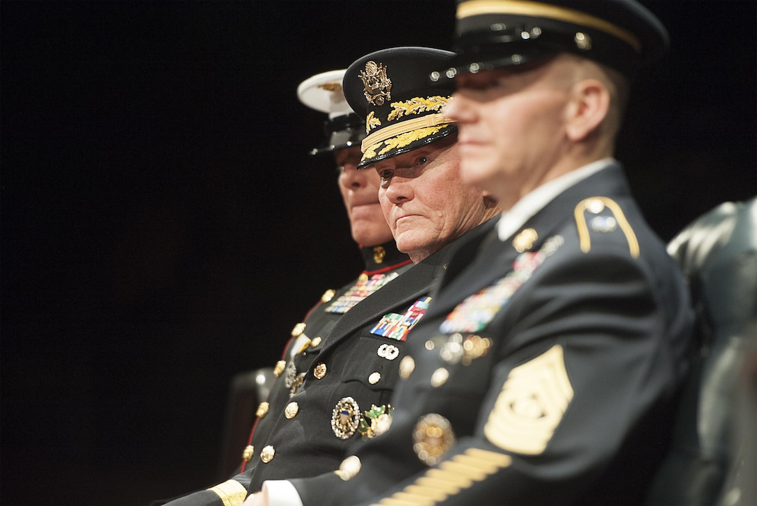 Retired Army Gen. Martin E. Dempsey, 18th chairman of the Joint Chiefs of Staff, listens as Marine Corps Gen. Joseph F. Dunford Jr., the current chairman, delivers remarks during the change of responsibility ceremony for the senior enlisted advisor to the chairman of the Joint Chiefs of Staff on Joint Base Myer-Henderson Hall, Va., Dec. 11, 2015. Army Command Sgt. Maj. John W. Troxell became the third senior enlisted advisor to the chairman of the Joint Chiefs of Staff, while Marine Corps Sgt. Maj. Bryan B. Battaglia retired after 36 years in service. DoD photo by Navy Petty Officer 2nd Class Dominique A. Pineiro