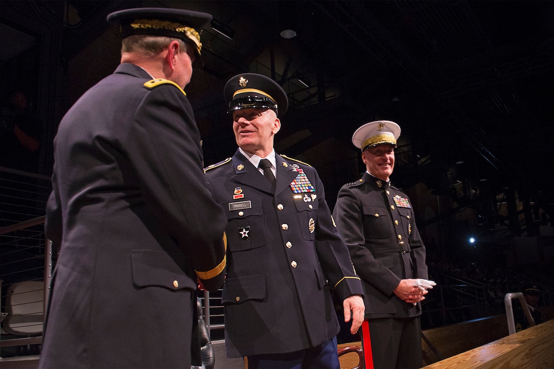 Army Command Sgt. Maj. John W. Troxell, the third senior enlisted advisor to the chairman of the Joint Chiefs of Staff, greets retired Army Gen. Martin E. Dempsey, 18th chairman of the Joint Chiefs of Staff, during a change of responsibility ceremony on Joint Base Myer-Henderson Hall, Va., Dec. 11, 2015. DoD photo by Navy Petty Officer 2nd Class Dominique A. Pineiro