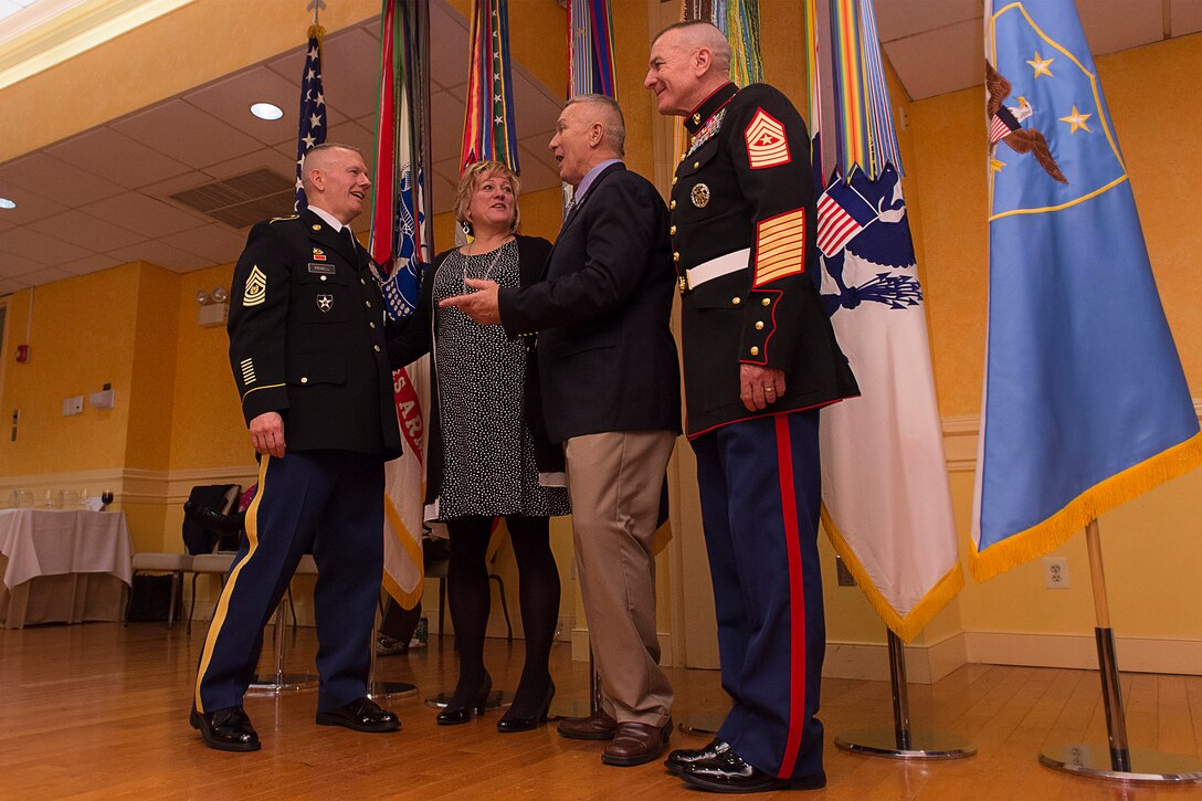 Army Command Sgt. Maj. John W. Troxell, third senior enlisted advisor to the chairman of the Joint Chiefs of Staff, introduces his sister to the first senior enlisted advisor to the chairman, retired Army Sgt. Maj. Joe Gainey, and recently retired Marine Corps Sgt. Maj. Bryan B. Battaglia, the second senior enlisted advisor to the chairman, during a reception following the change of responsibility ceremony on Joint Base Myer-Henderson Hall, Va., Dec. 11, 2015. DoD photo by Navy Petty Officer 2nd Class Dominique A. Pineiro