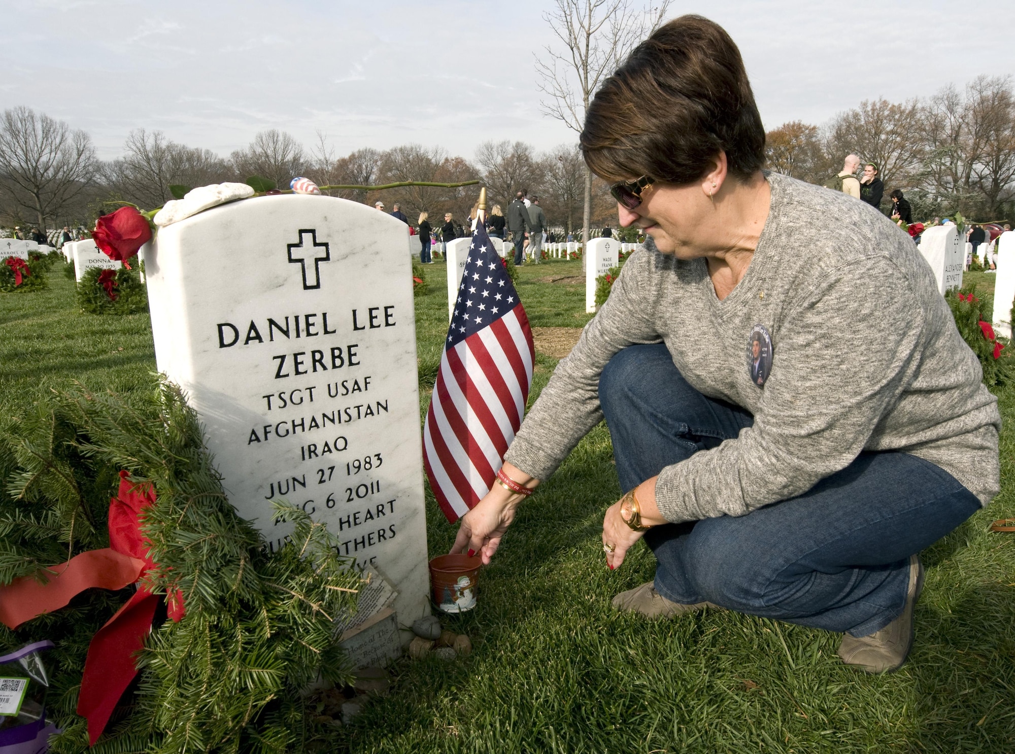 Susan Zebre prepares to place a wreath on the headstone for her son, Tech. Sgt. Daniel Lee Zerbe, who was one of 30 U.S. troops killed when a CH-47 Chinook helicopter was shot down in Afghanistan in 2011. Susan and other family members of fallen troops and thousands of volunteers were at the Arlington National Cemetery on Dec. 12, 2015, for Wreaths Across America Day, an event to honor those who died defending the country. (U.S. Air Force photo/Sean Kimmons)