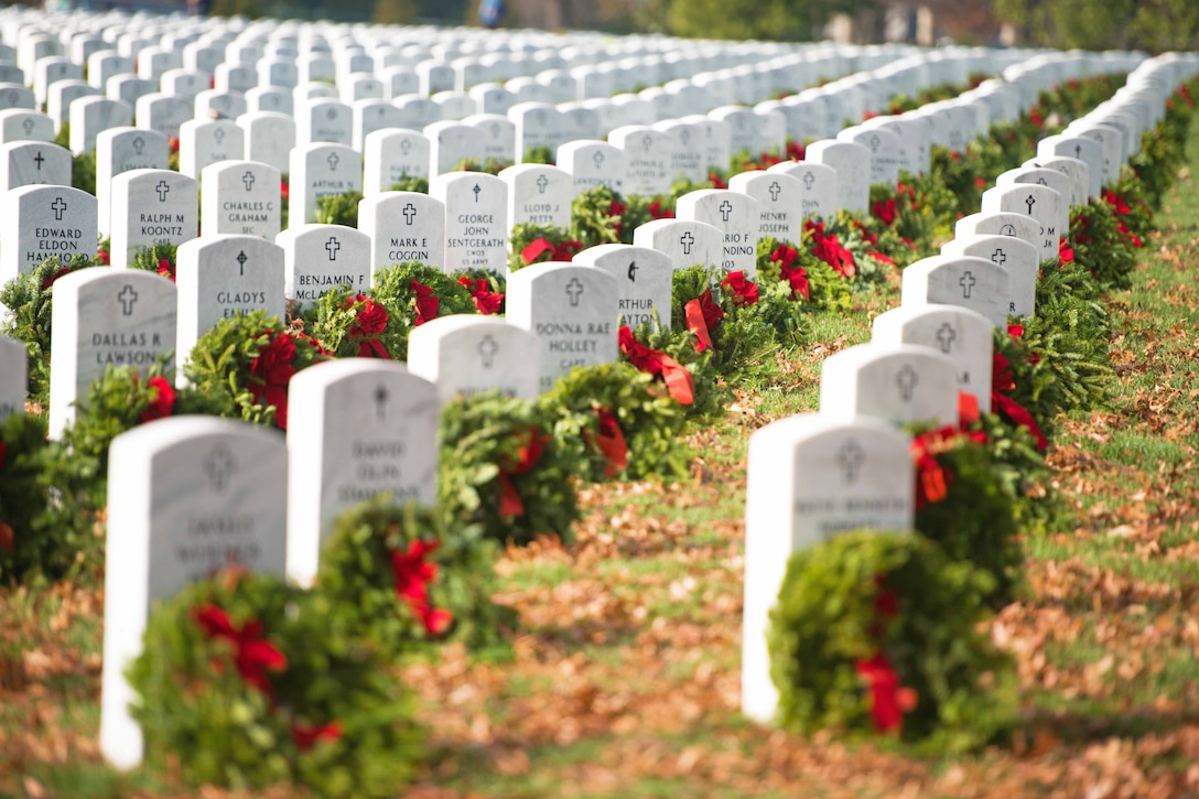 Wreaths adorn headstones following the annual Wreaths Across America event in Arlington National Cemetery, Arlington, Va., Dec. 12, 2015. Volunteers with the nonprofit organization placed a wreath on every eligible headstone in the cemetery to remember and honor the fallen. U.S. Army photo by Rachel Larue