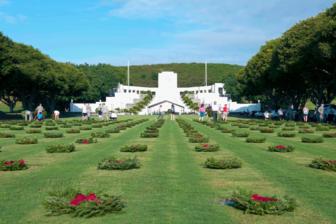 Wreaths adorn the gravestones of service members following a wreath-laying ceremony as part of Wreaths Across America at the National Memorial Cemetery of the Pacific in Honolulu, Dec. 12, 2015. U.S. Navy photo by Petty Officer 2nd Class Jeff Troutman