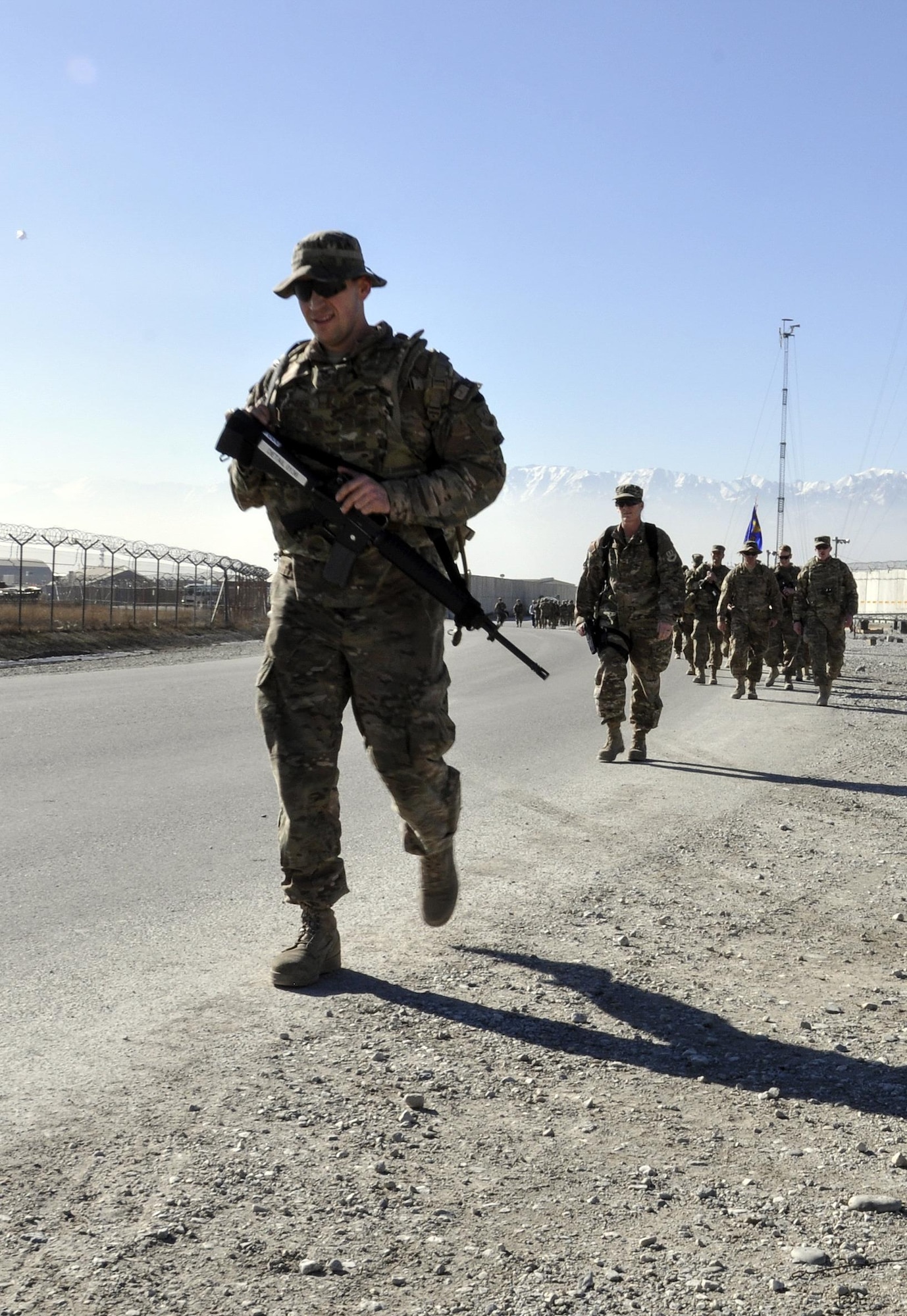 Staff Sgt. Ryan Bender, 455th Expeditionary Maintenance Squadron, leads a group of Bagram service members in the “Ruck to Remember,” a 12-kilometer ruck march at Bagram Airfield, Afghanistan Dec. 12, 2015. The event was designed to honor the sacrifices these Defenders made and to celebrate their lives. (U.S. Air Force photo by Tech. Sgt. Nicholas Rau/Released)
