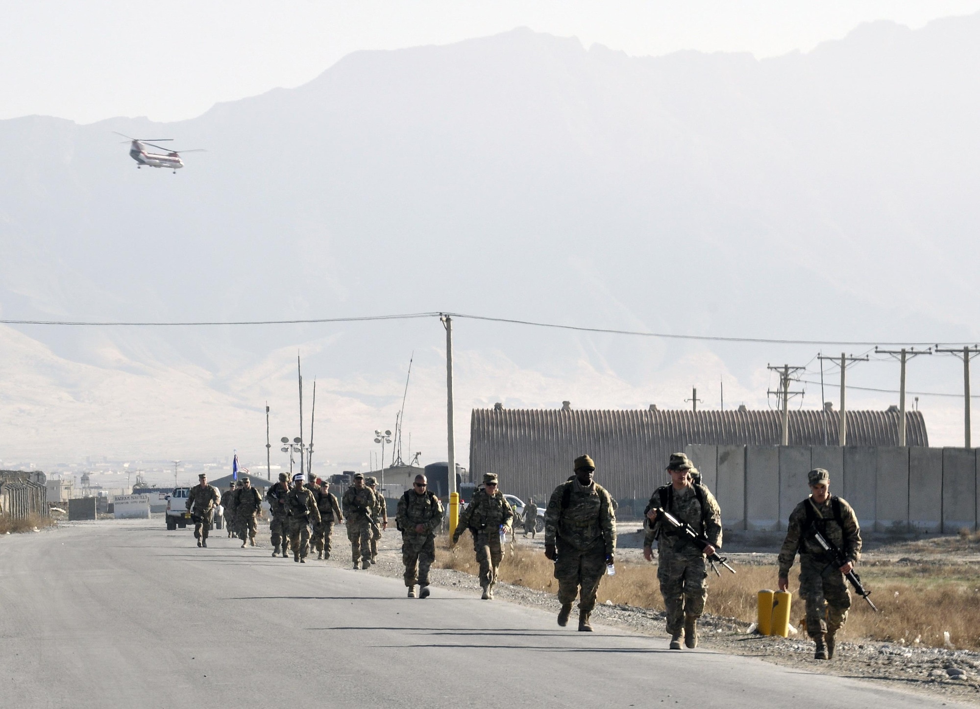 Bagram service members march during the “Ruck to Remember,” a 12-kilometer ruck march at Bagram Airfield, Afghanistan Dec. 12, 2015. The event was designed to honor the sacrifices these Defenders made and to celebrate their lives. (U.S. Air Force photo by Tech. Sgt. Nicholas Rau/Released)
