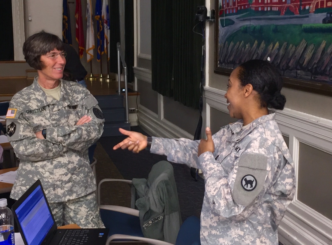 Capt. LaToya Kearns, 81st Regional Support Command Retirement Services Officer, shares a laugh with Col. Julia Christian, an attendee from USARE-COTS, during a Pre-Retirement Services brief at the Lexington, Ky. VA Medical Center Dec. 5. The 81st RSC hopes to partner with the VA for all future briefs in order to provide better service to retiring service members.