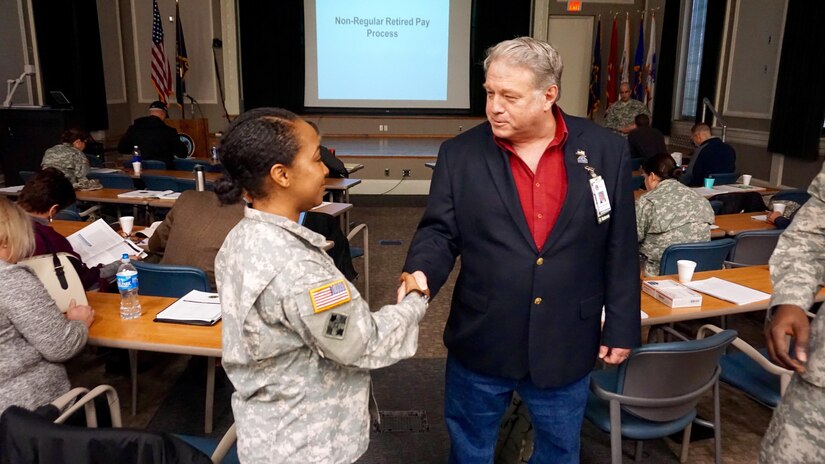 Capt. LaToya Kearns, Retirement Services Officer for the 81st Regional Support Command, and Mr. James Belmont, Jr., Associate Director of the Lexington VA Medical Center exchange thanks during a briefing. The 81st RSC presented a Pre-Retirement Services brief at the Lexington, Ky. VA Medical Center Dec. 5. The 81st RSC hopes to partner with the VA for all future briefs in order to provide better service to retiring service members.