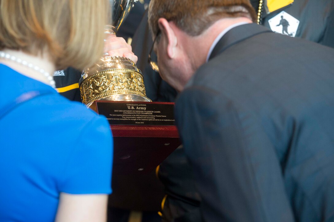 Defense Secretary Ash Carter reads the inscription on the Warrior Games trophy at the 2015 Army-Navy football game in Philadelphia, Dec. 12, 2015. DoD photo by Navy Petty Officer 1st Class Tim D. Godbee