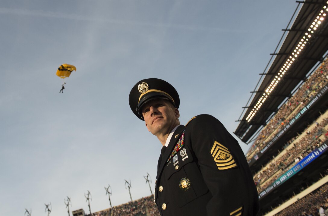 Sgt. Maj. of the Army Daniel A. Dailey looks on as members of the U.S. Army parachute team, the Golden Knights, fly into the stadium before the 116th Army-Navy football game in Philadelphia, Dec. 12, 2015. DoD photo by Navy Petty Officer 2nd Class Dominique A. Pineiro