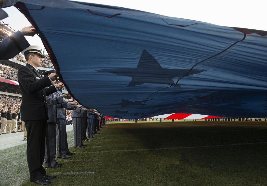 An Army-Navy color guard unfurl the American flag during the national anthem at the 116th Army-Navy football game in Philadelphia, Dec. 12, 2015. DoD photo by Navy Petty Officer 2nd Class Dominique A. Pineiro