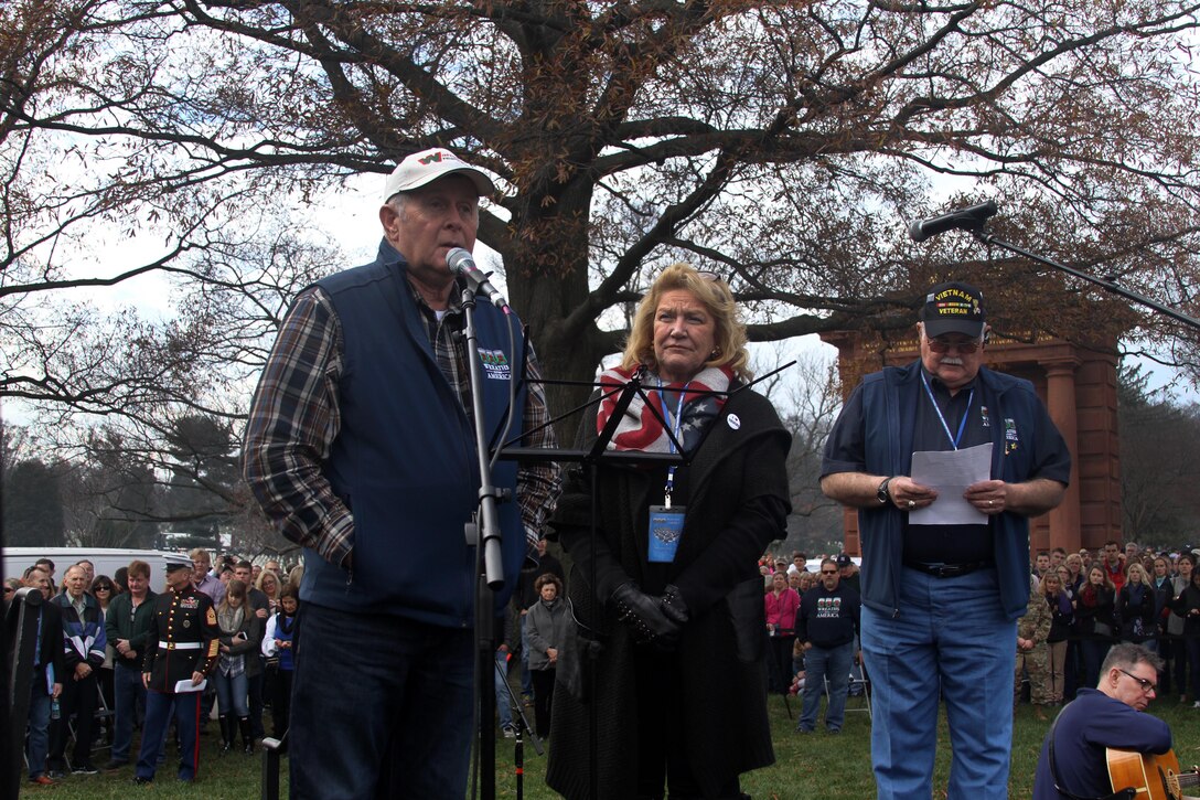Morrill Worcester, left, founder and executive director of Wreaths Across America, accompanied by his wife, Karen, addresses thousands of service members and volunteers during opening remarks at Arlington National Cemetery in Arlington, Va., Dec. 12, 2015. DoD photo by Sebastian Sciotti Jr.
