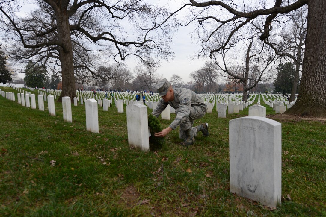 Air Force Senior Airman Joseph Wood places a wreath on a grave marker during the annual Wreaths Across America event at Arlington National Cemetery in Arlington, Va., Dec. 12, 2015. Wood is an honor guard member assigned to the U.S. Air Force, Joint Base Anacostia–Bolling, Washington, D.C. DoD photo by Sebastian Sciotti Jr.


