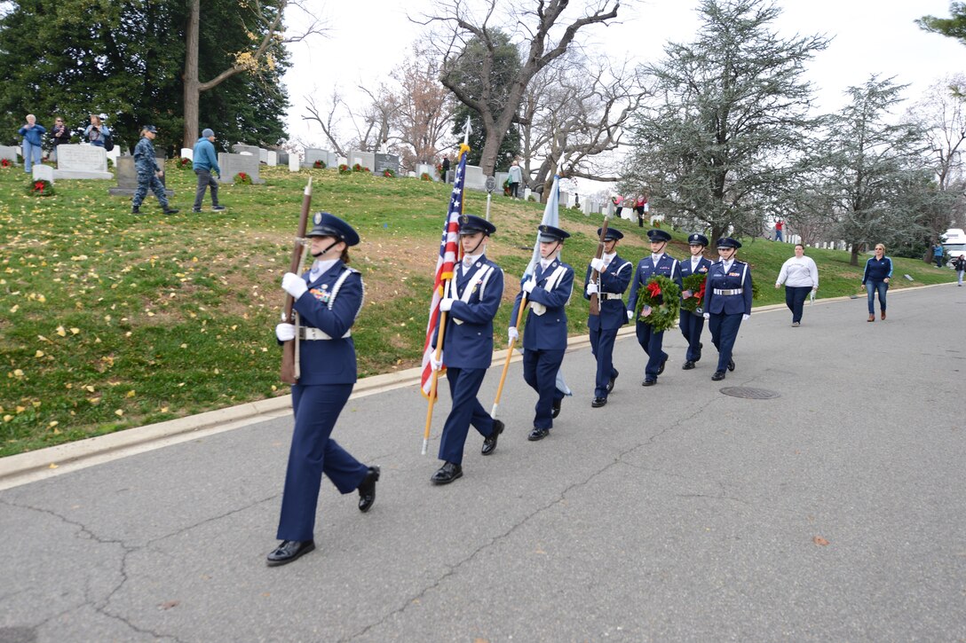 Air Force Junior ROTC cadets carry a wreath to be placed at a grave marker during the annual Wreaths Across America event at Arlington National Cemetery in Arlington, Va., Dec. 12, 2015. DoD photo by Sebastian Sciotti Jr.
