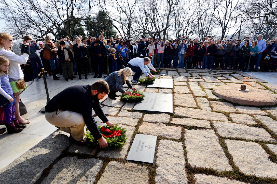 From left to right; Eric, Bessy, Kenneth and Emily Cianchectte place wreaths at the grave markers of the late president John F. Kennedy, Jacqueline Kennedy and children during the annual Wreaths Across America event at Arlington National Cemetery in Arlington, Va., Dec. 12, 2015. DoD photo by Sebastian Sciotti Jr.
