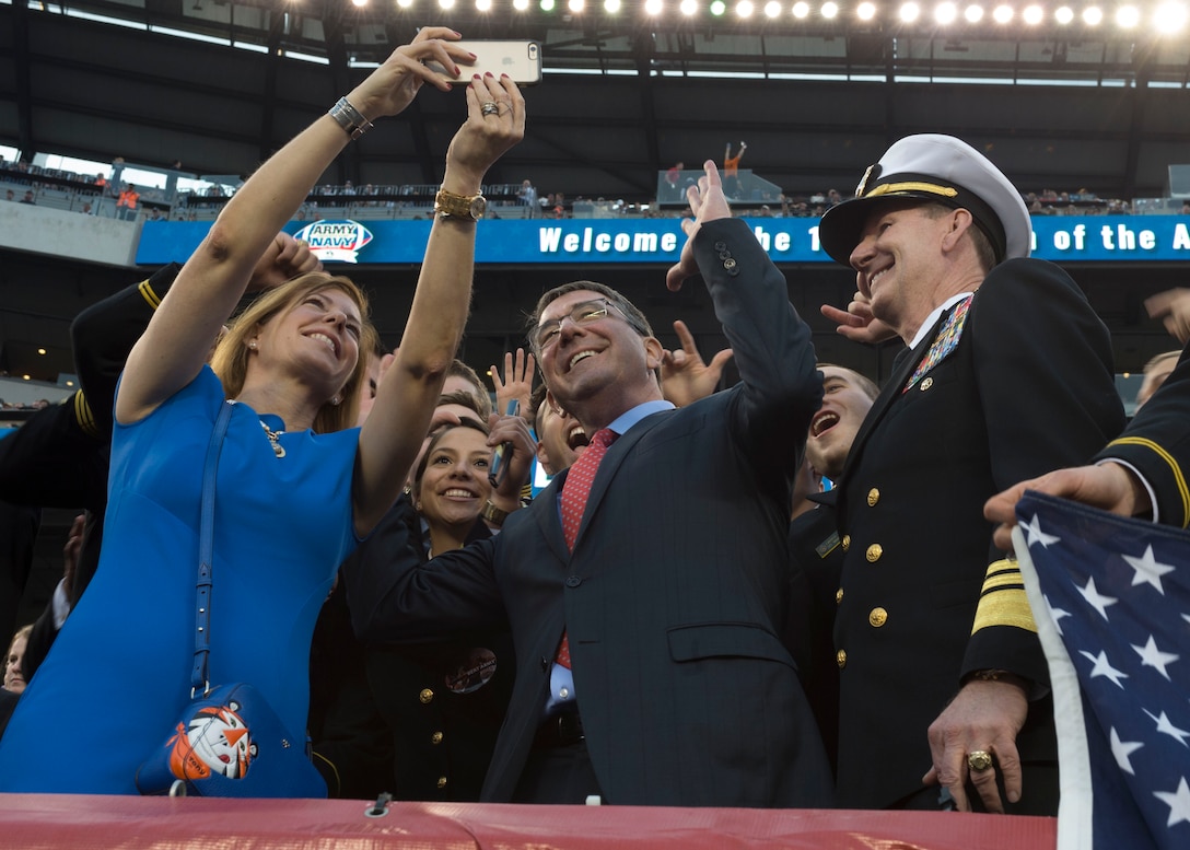 Defense Secretary Ash Carter and his wife, Stephanie, takes a selfie with Naval Academy midshipmen at the 2015 Army-Navy football game in Philadelphia, Dec. 12, 2015. DoD photo by Petty Officer 1st Class Tim D. Godbee