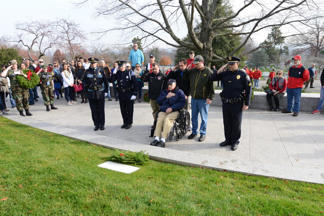 Arthur Best, center, a World War II veteran, family members, Janine L. Roberts, left, Police Chief of Westbrook, and Kevin Haley, second left, a police officer from Portland, Maine, render honors after placing a wreath at the grave marker of the late Robert Francis "Bobby" Kennedy during the annual Wreaths Across America event at Arlington National Cemetery, Arlington, Va., Dec. 12, 2015. DoD photo by Sebastian Sciotti Jr.