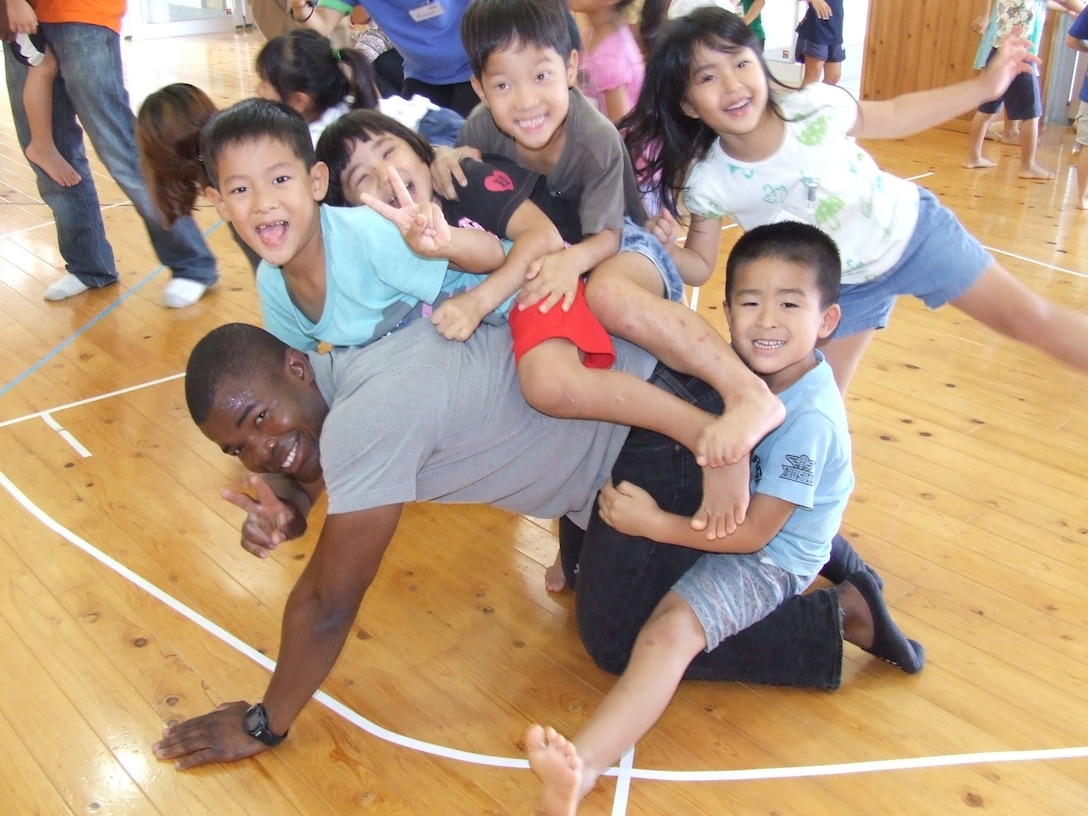 NAGO, Okinawa, Japan – Cpl. Oluwaseun Bello from Combat Assault Battalion, 3rd Marine Division, spend the day with local children at Asunaro Nursery School during the Single Marine Program Volunteer opportunity at the school Nov. 12, 2015. The Marines of CAB routinely volunteer in the local communities of Henoko and Nago, Okinawa.  