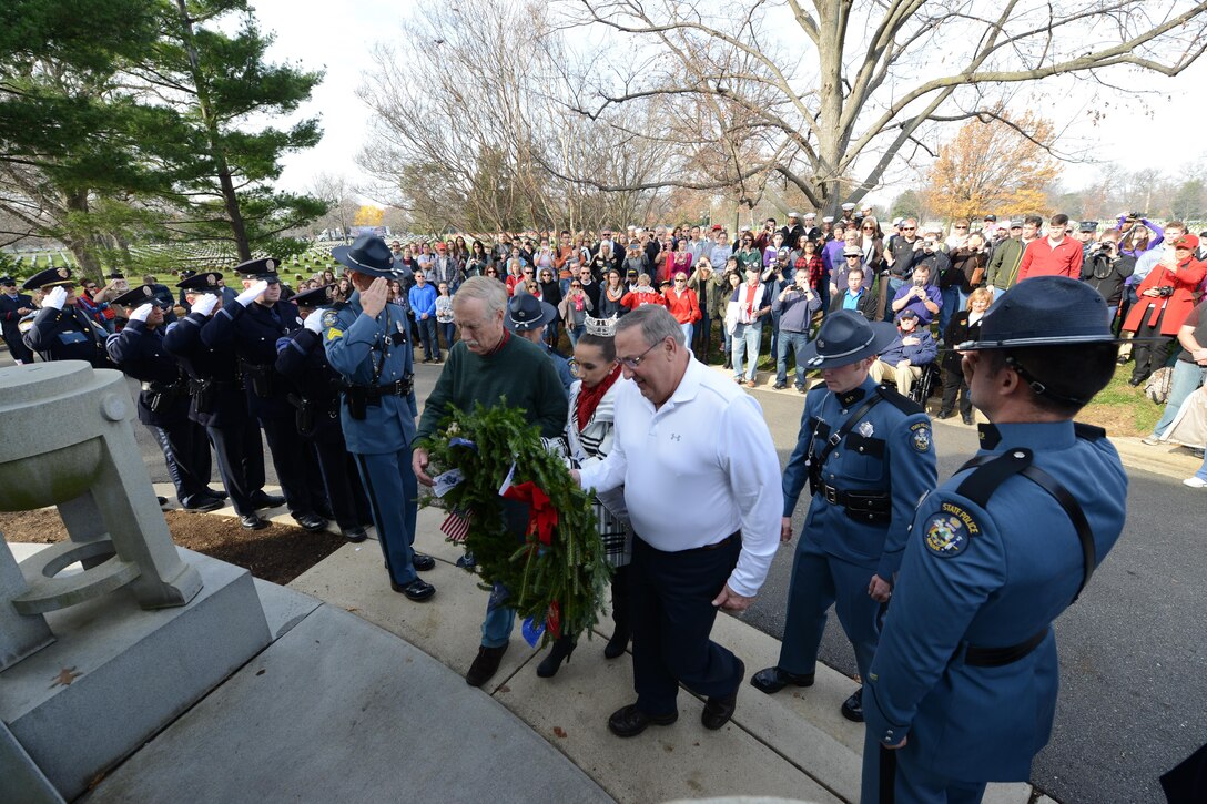 Sen. Angus Stanley King Jr. from Maine, center left, Maine Gov. Paul LePage, center right, and Miss Maine place a wreath at the USS Maine Mast during the annual Wreaths Across America event at Arlington National Cemetery in Arlington, Va., Dec. 12, 2015. DoD photo by Sebastian Sciotti Jr.
