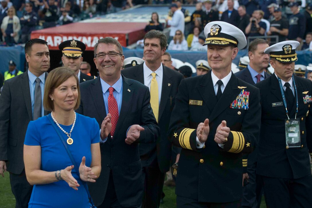 Defense Secretary Ash Carter walks the sidelines with his wife, Stephanie, and U.S. Naval Academy Superintendent Navy Vice Adm. Ted Carter during the  2015 Army-Navy football game in Philadelphia, Dec. 12, 2015. Navy beat Army for the 14th consecutive year, 21-17. DoD photo by Navy Petty Officer 1st Class Tim D. Godbee.