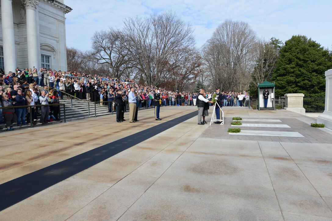 A member of the U.S. Army Honor Guard, 3rd U.S. Infantry Regiment (The Old Guard), helps volunteers with a wreath to be placed at the Tomb of the Unknown Soldier at Arlington National Cemetery in Arlington, Va., Dec. 12, 2015. DoD photo by Sebastian Sciotti Jr.
