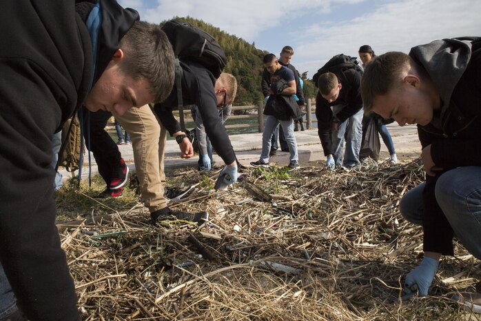 Marines and Sailors clean up Katazoe Beach on Oshima Island, Japan, during the Oshima Cleanup Dec. 12, 2015. Organized by Marine Aircraft Group 12 Chaplain’s office and the Single Marine Program from Marine Corps Air Station Iwakuni, this cleanup and similar monthly community relations events help keep the local community clean as well as give service members a chance to explore Japan.