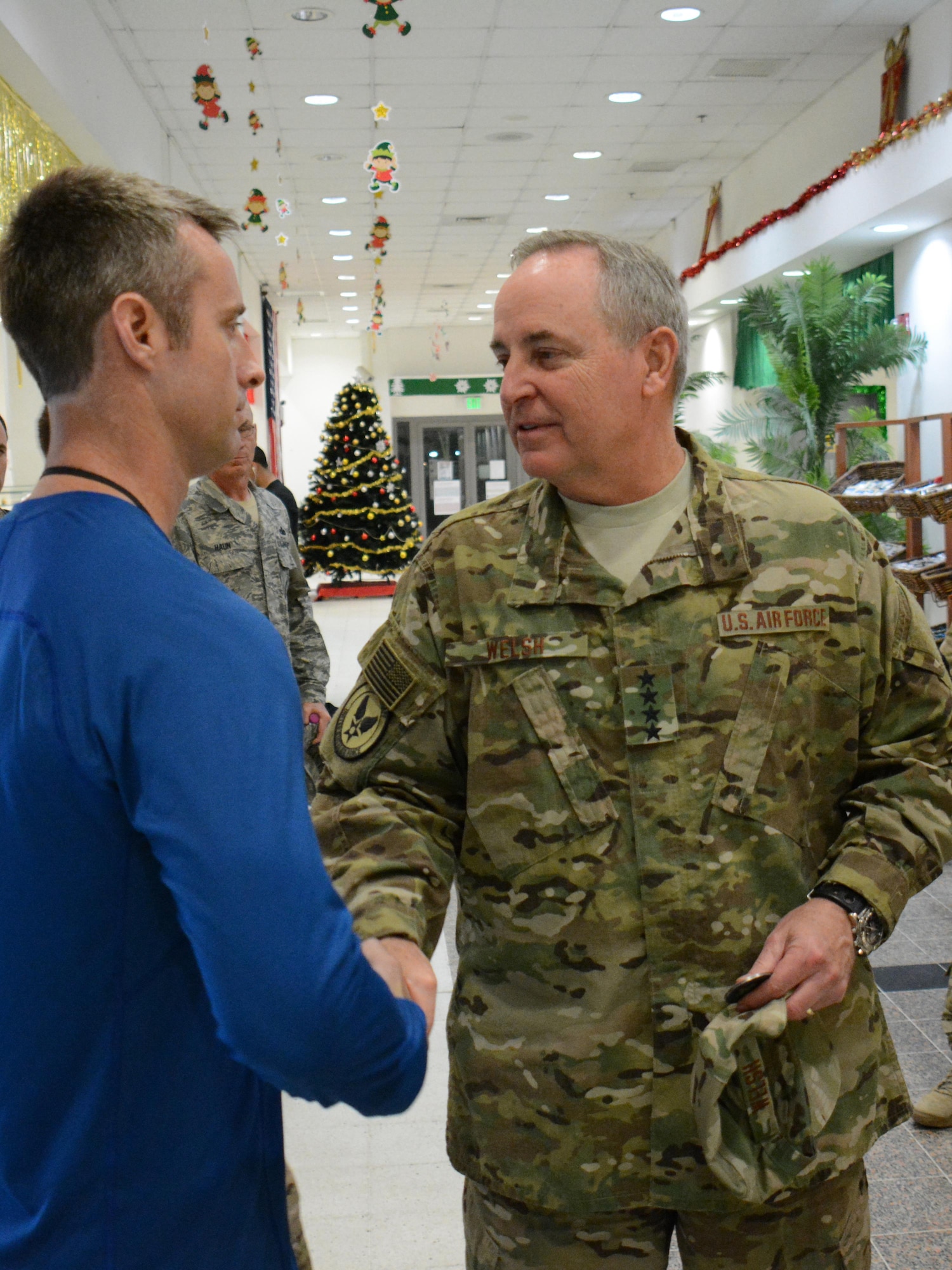 Gen. Mark Welsh III, Chief of Staff of the Air Force, greets a deployed service member in the Blatchford-Preston Complex Dining Facility at Al Udeid Air Base, Qatar Dec. 11. Welsh met with deployed service members during his visit to AUAB and thanked them for their service. (U.S. Air Force photo by Tech. Sgt. James Hodgman/Released)