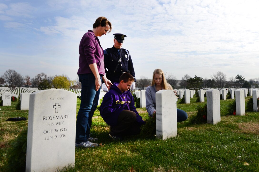 William, Emily, Miriam and Kevin Haley, a police officer from Portland, Maine, lay a wreath at the headstone of brother William Haley during the annual Wreaths Across America event at Arlington National Cemetery in Arlington, Va., Dec. 12, 2015. Kevin Haley is an advisory board member of Wreaths Across America, the Maine-based nonprofit that shipped 240,815 wreaths to Arlington. DoD photo by Sebastian Sciotti Jr.
