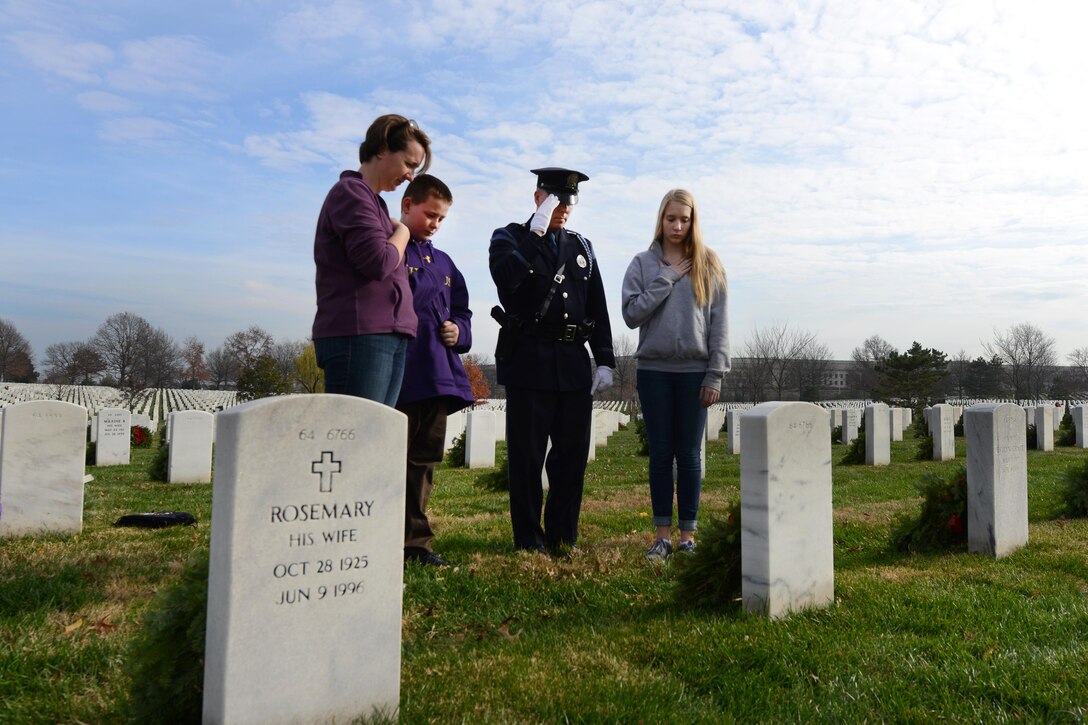 William, Emily, Miriam and Kevin Haley, a police officer from Portland, Maine, render honors after placing a wreath against the headstone of brother William Haley during the annual Wreaths Across America event at Arlington National Cemetery in Arlington, Va., Dec. 12, 2015. DoD photo by Sebastian Sciotti Jr.