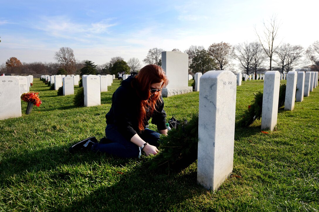 Amanda Meixell from Redding, Pa., pauses for a moment and reflects on the loss of a close friend after placing a wreath at his grave marker during the annual Wreaths Across America event at Arlington National Cemetery in Arlington, Va., Dec. 12, 2015. DoD photo by Sebastian Sciotti Jr.
