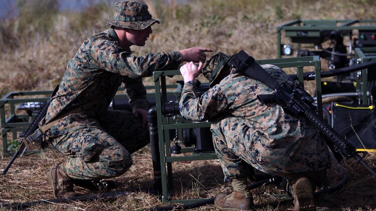 Lance Cpl. Quentin J. Stallings, left, and Lance Cpl. Kyle H. Clemens, right, configure the settings on a water pump and filter at Marine Corps Auxiliary Landing Field Bogue, N.C., Dec. 9, 2015. Marines with Marine Wing Support Squadron 271’s Engineer Company participated in a cantonment and capabilities field exercise to practice and improve their knowledge of their jobs while in a deployed environment. The weeklong exercise featured events such as airfield damage repair, water purification, medium and heavy lifting missions, with the construction of an expedient road for a vertical take-off and landing aircraft pad. Stallings and Clemens are both water support technicians with MWSS-271.